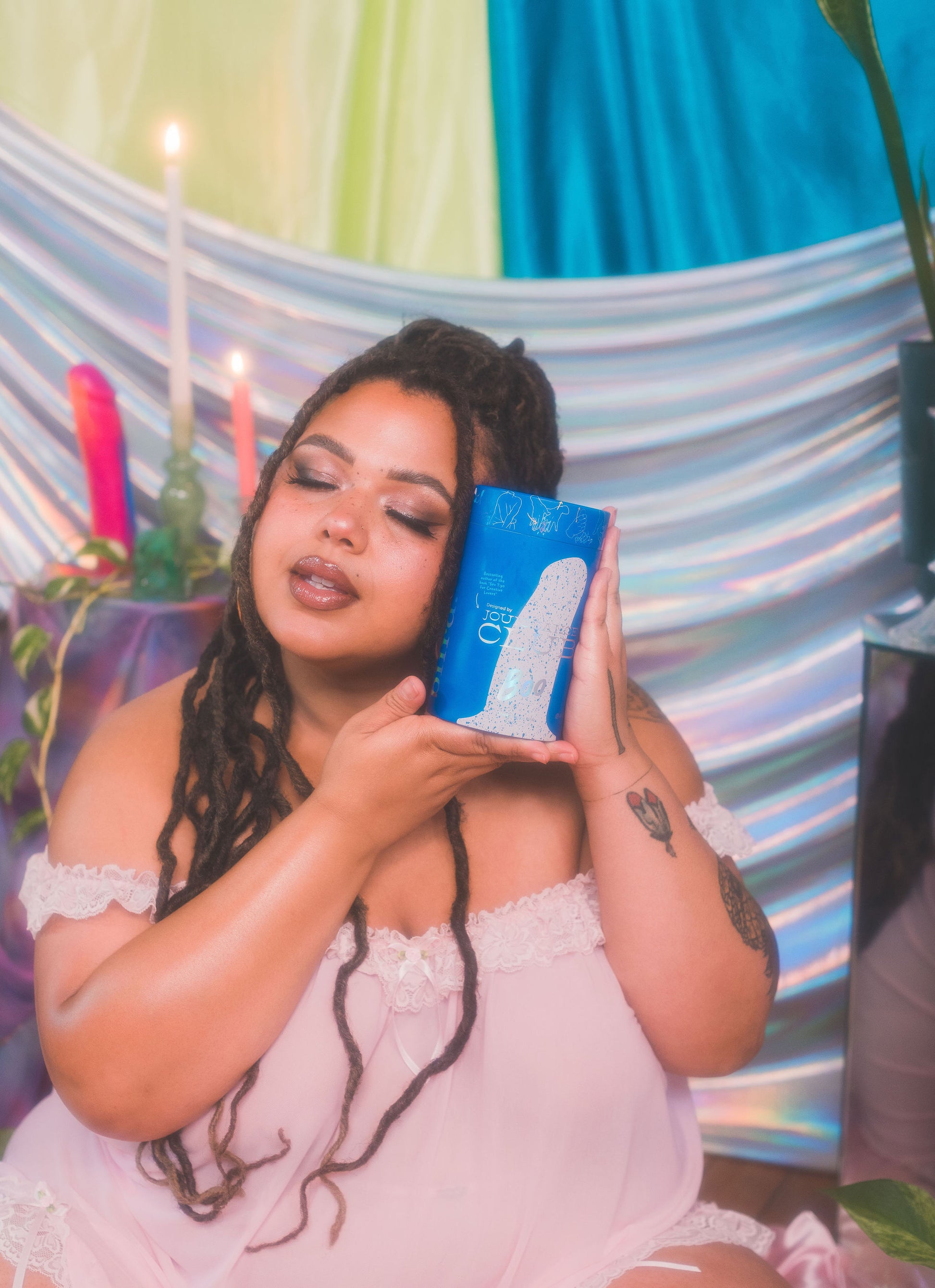 Woman holding a blue box with colorful background