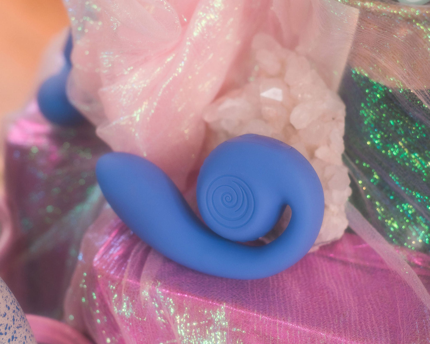 Close-up of a blue Snail Vibe SVibe GIZI Lite with pink and glittery background