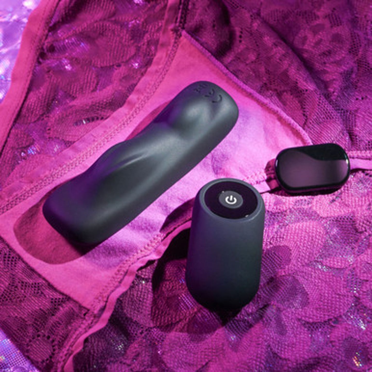 Black electronic Gender X Our Undie Vibe on pink lace fabric