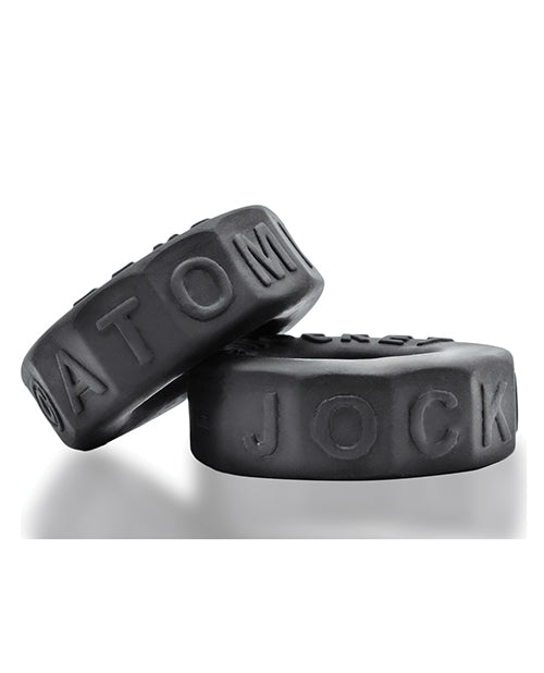Two black Oxballs Sprocket No-Roll Cock Ring  with 'ATOM' and 'JOCK' embossed on a white background