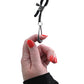 Hand holding tuggable nipple clamps 