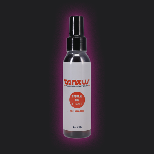 Bottle of Tantus natural toy cleaner on a dark background