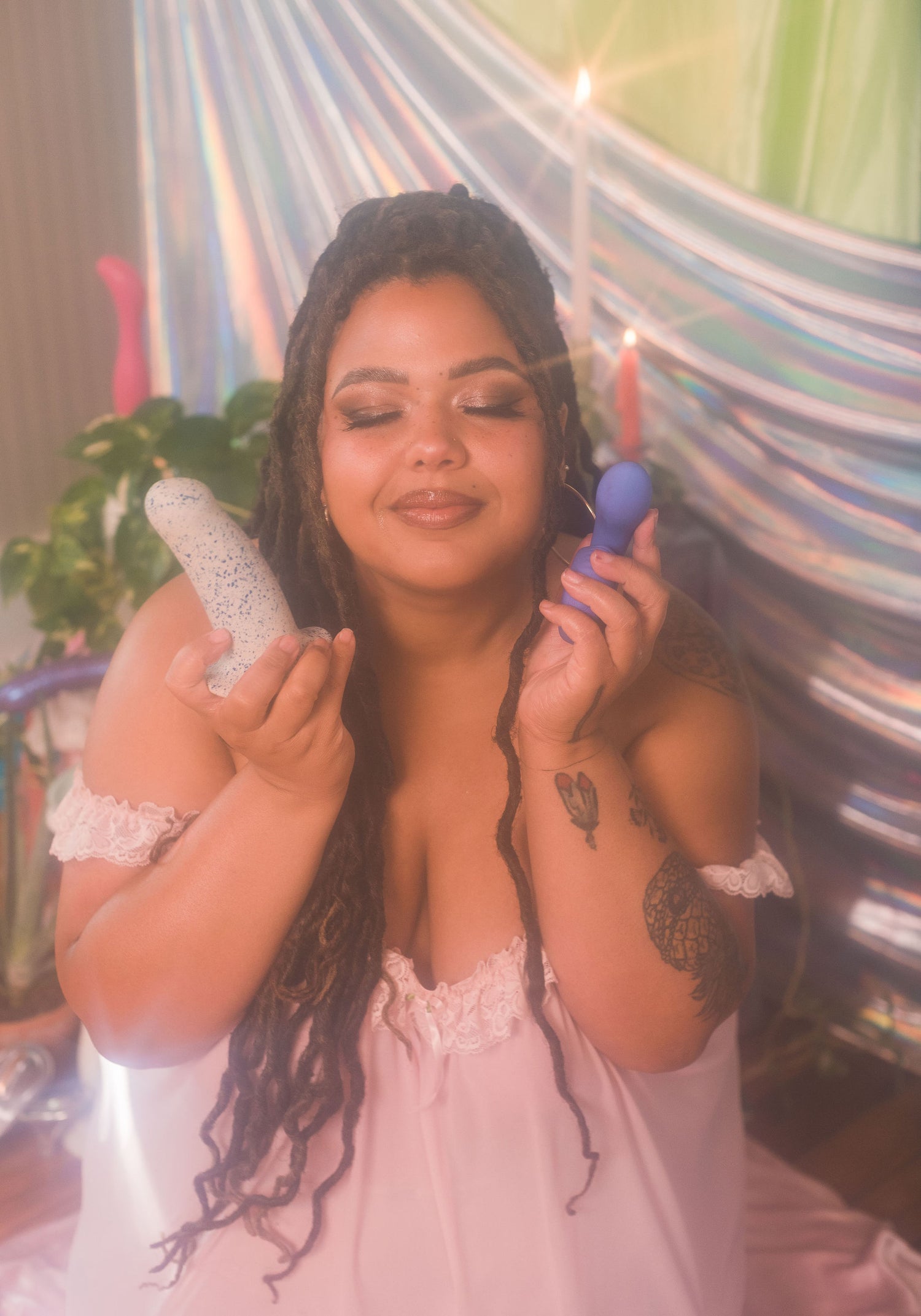 Woman holding two silicone toys in a hammock