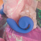 Close-up of a blue Snail Vibe SVibe GIZI Lite with pink and glittery background