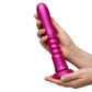 Pink ROMP Jiggle Thrusting Vibrator held in a hand against a white background