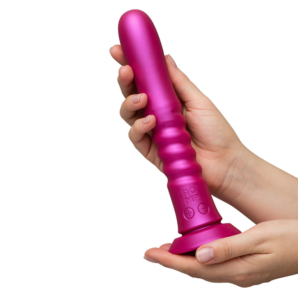Pink ROMP Jiggle Thrusting Vibrator held in a hand against a white background