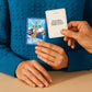 Two people holding Biird x Jouissance Club Together Couples Card Game against a blue textured sweater background