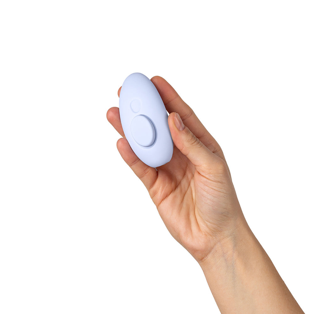 Hand holding Dame Lay Panty Vibrator on a white background