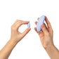 Two hands holding Dame Lay Panty Vibrator against a white background