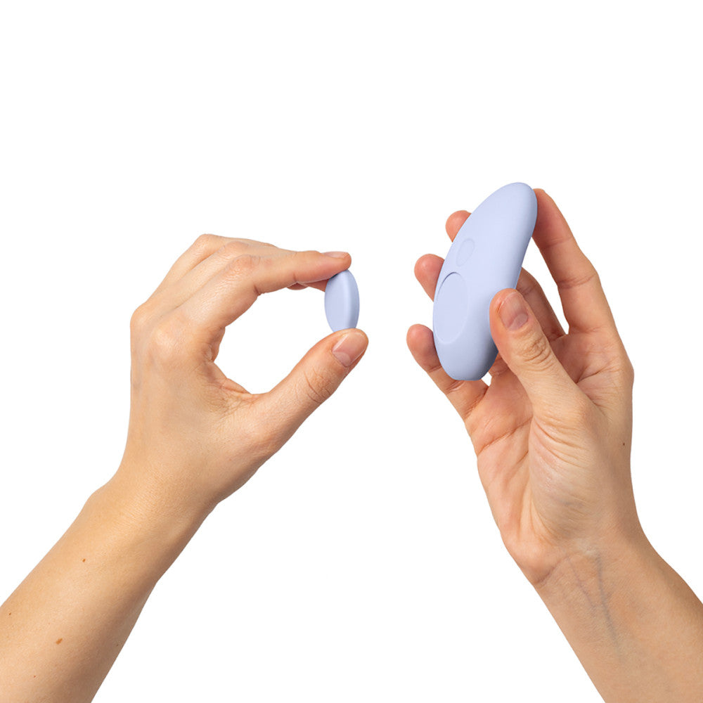 Two hands holding Dame Lay Panty Vibrator against a white background