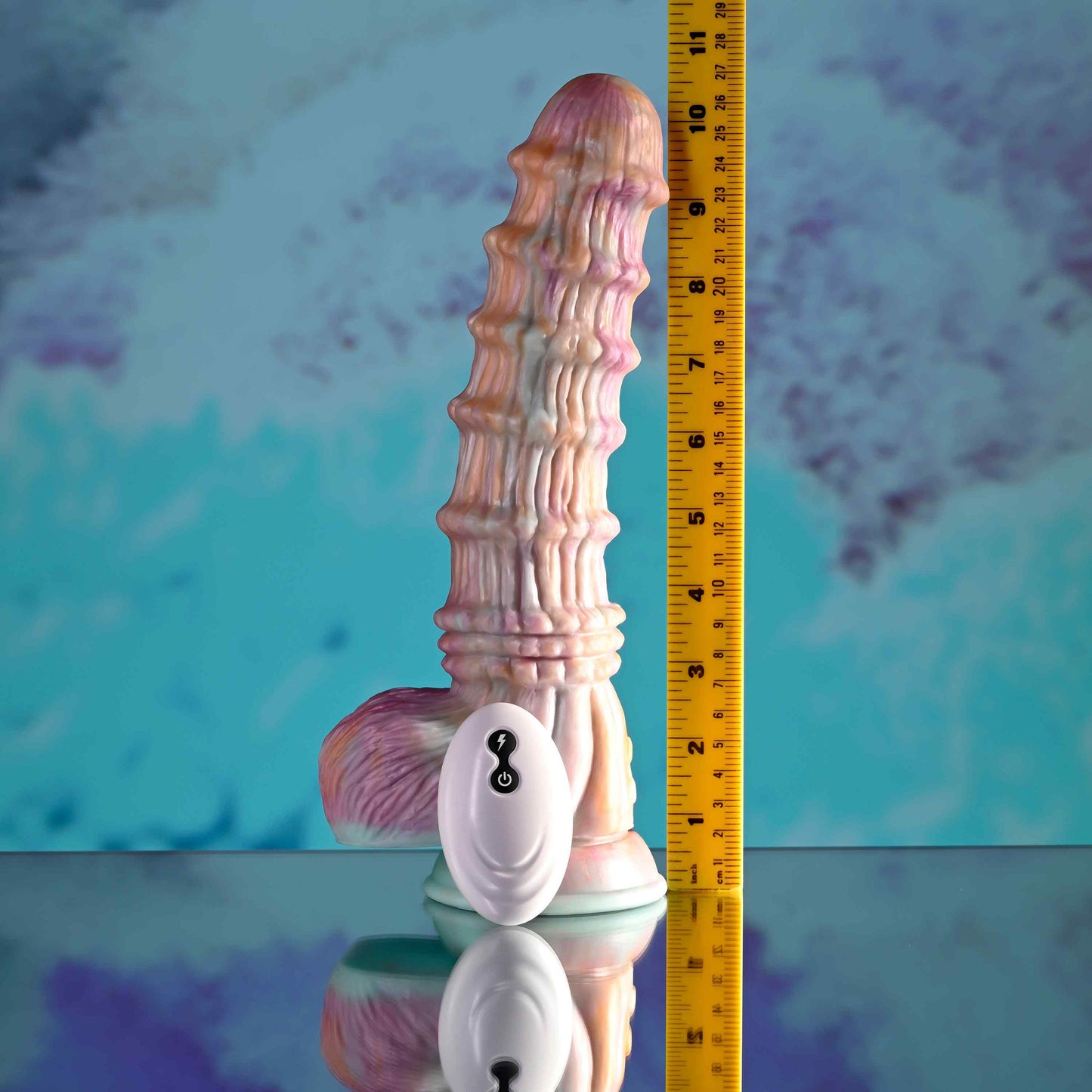 Evolved Fantasy Ridged Dildo on a blue textured background, accompanied by a ruler for scale.