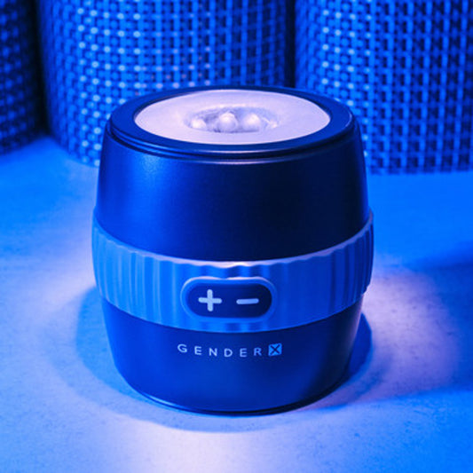 Gender X Barrel Of Fun Vibrating Stroker against a blue textured background.