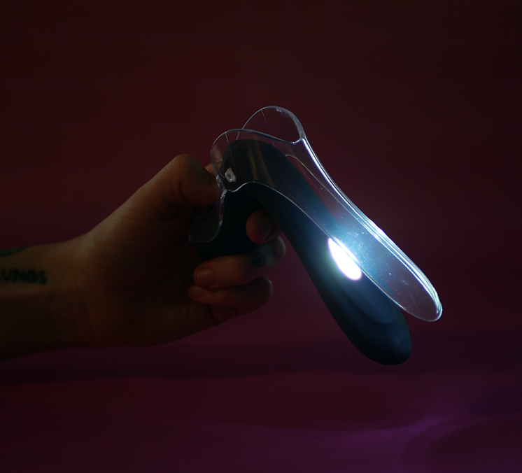 INYA GynoVibe LED Speculum Vibrator glowing in the dark with it's internal light