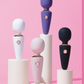 Set of colorful Le Wand Mini Micro Wand on white stands against a pink background