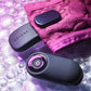 Black and pink electronic vibrator with 'GENDERX' branding on a purple textured background.