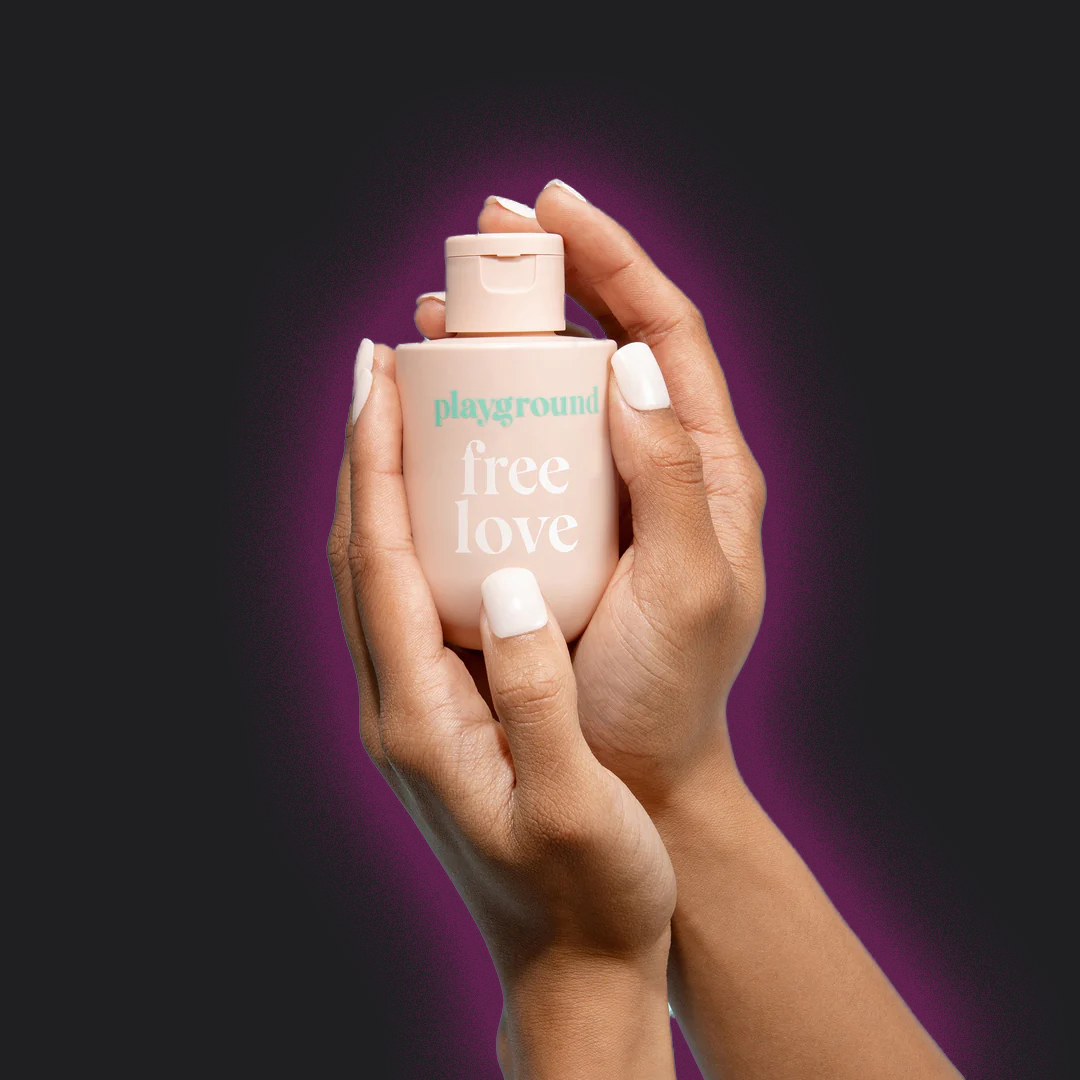 Playground Free Love Water Based Lubricant being held