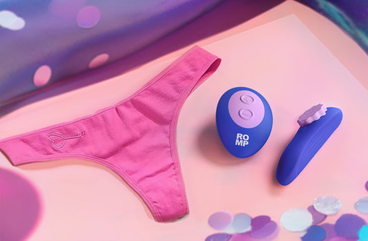 Pink underwear and two blue sex toys on a colorful background