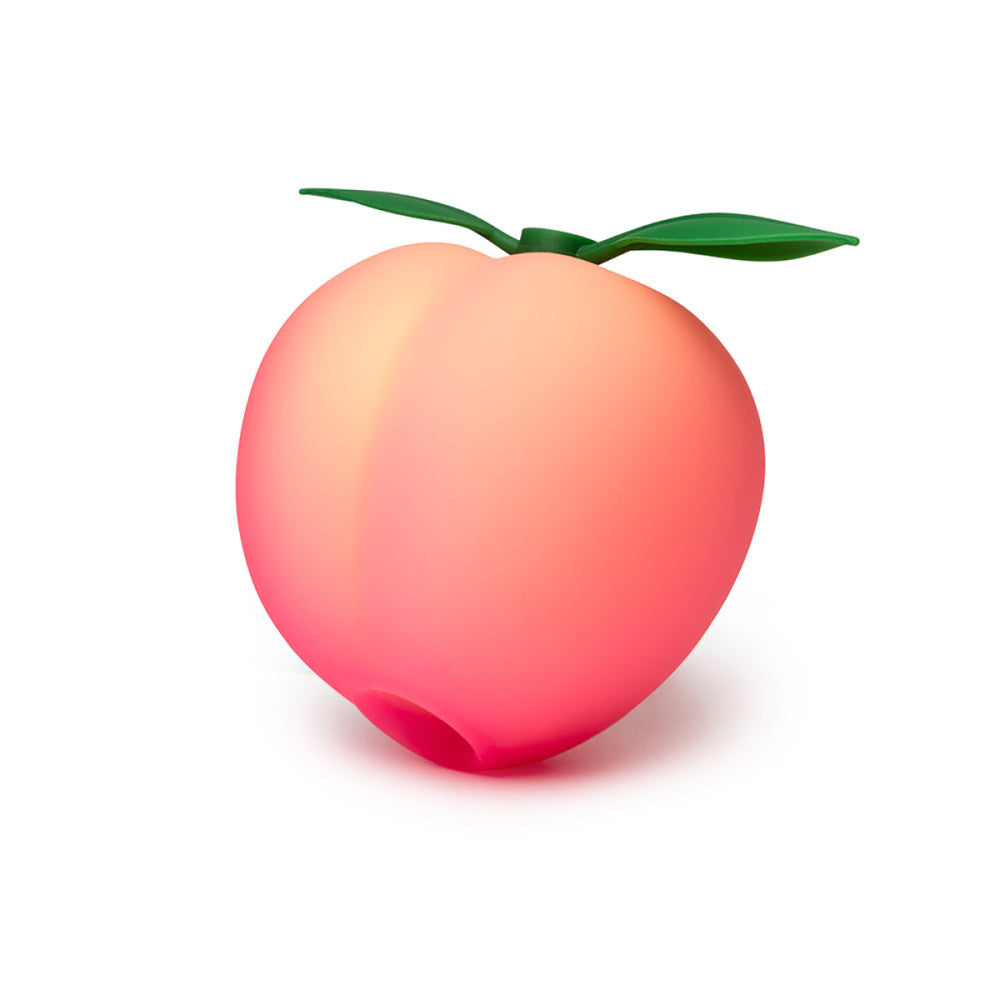 Romp Pink Peach Vibrator  with a green leaf on a white background