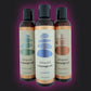 Three bottles of sliquid massage oil on a purple background