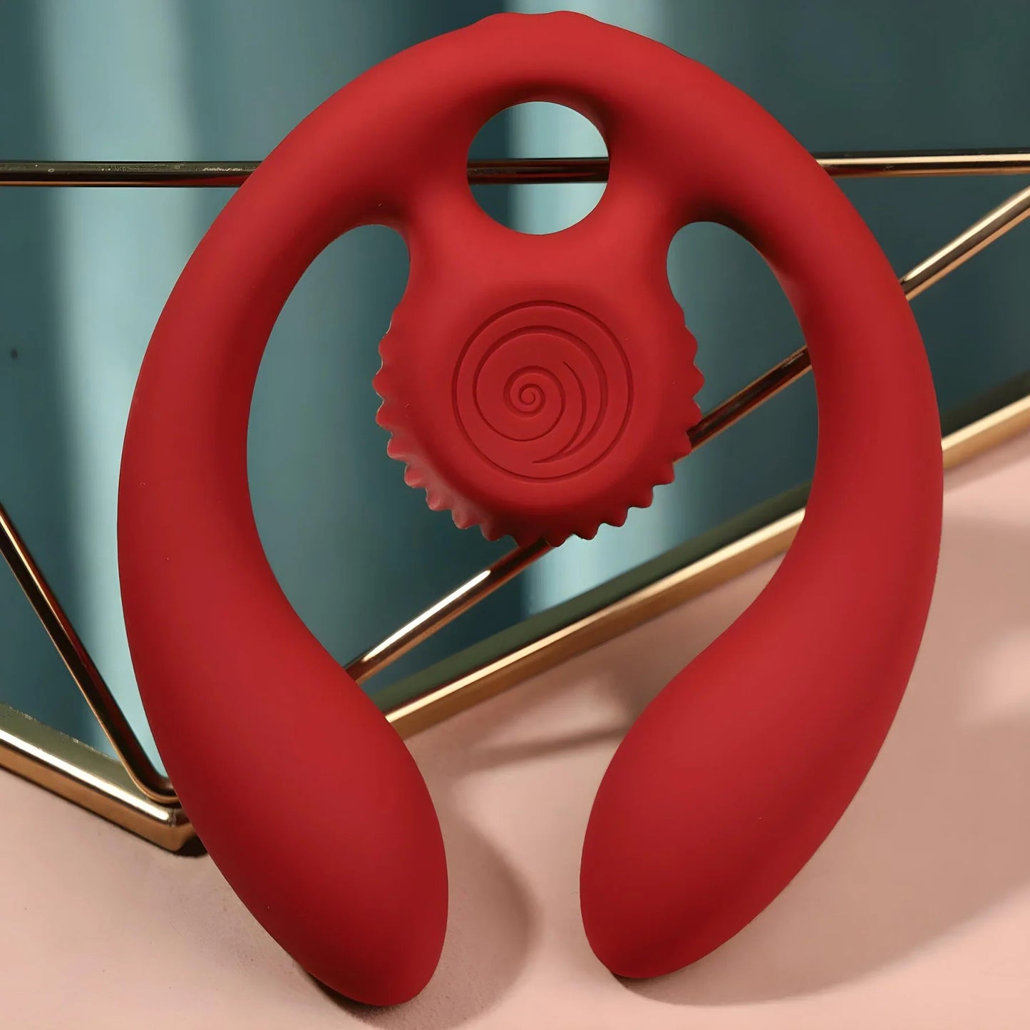 Red silicone SVibe Snail GIZI Duo Double Ended Dildo And Vibe on a stand with a blue background