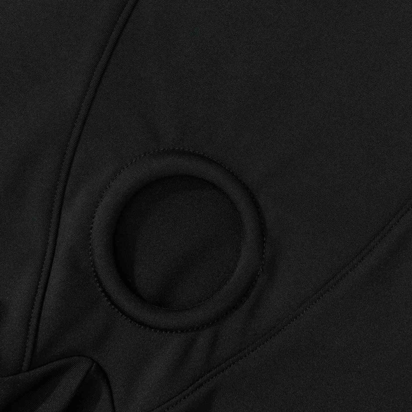 Close-up of black fabric with a circular pattern