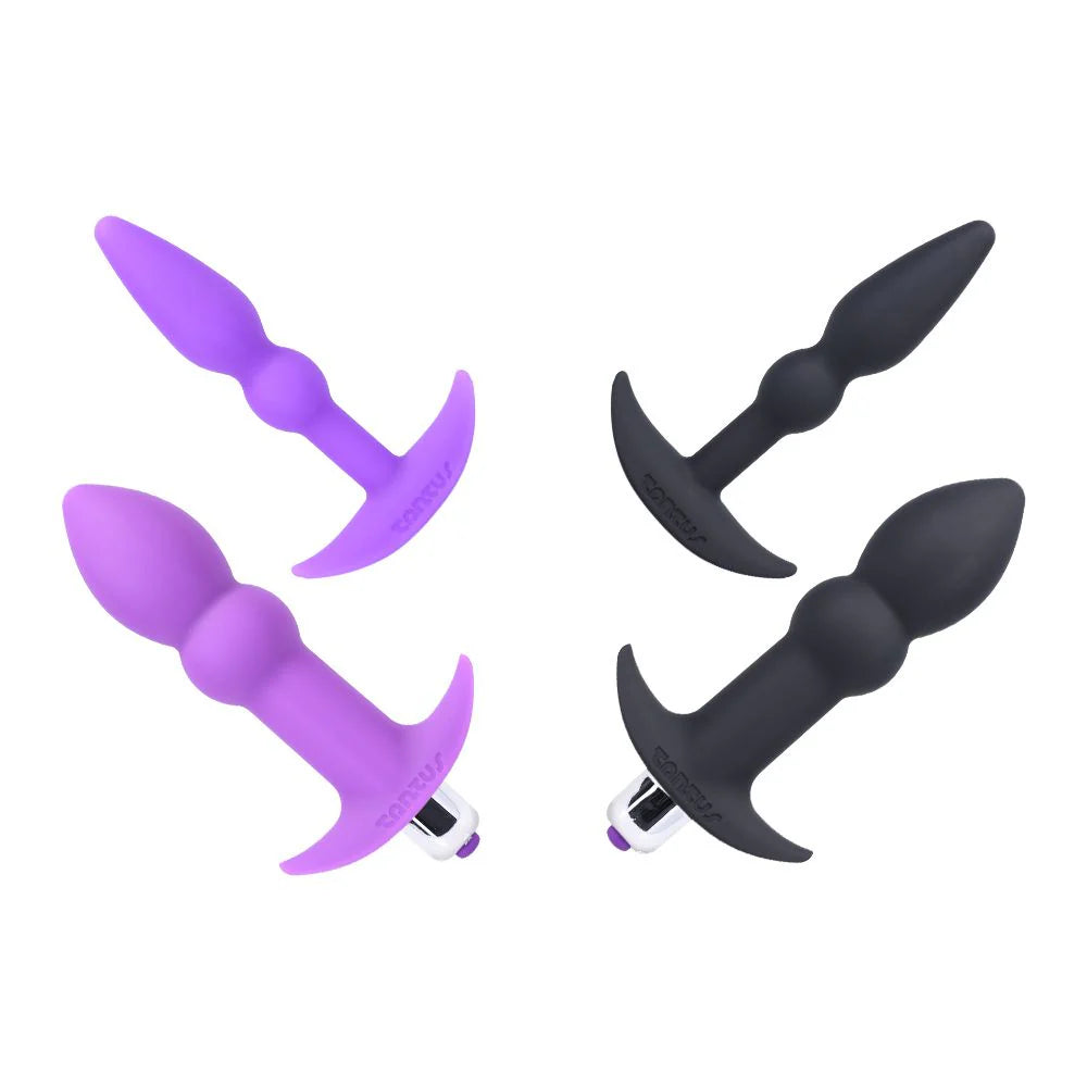 Two purple and two black silicone butt plugs on a white background
