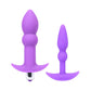 Two purple silicone butt plugs on a white background