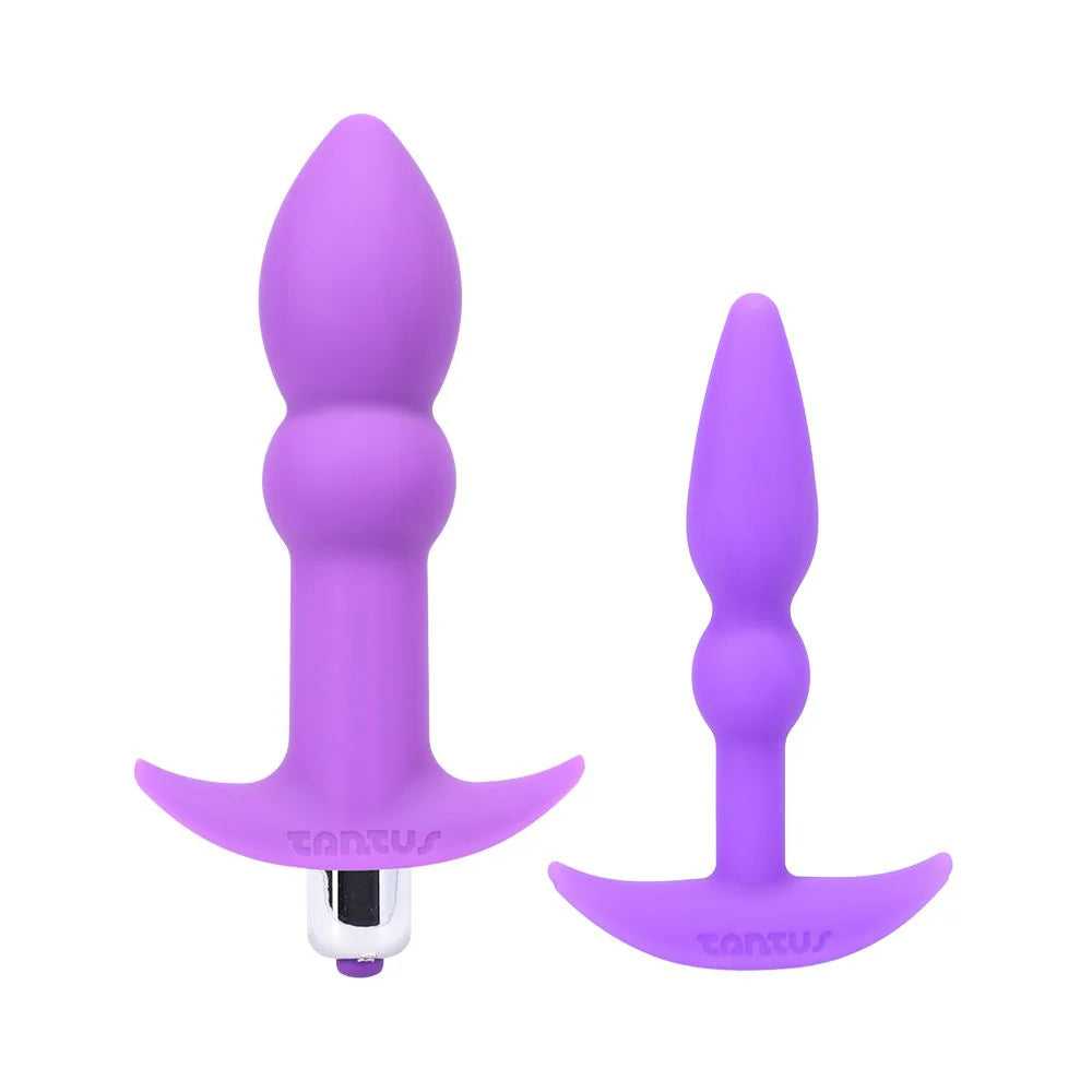 Two purple silicone butt plugs on a white background