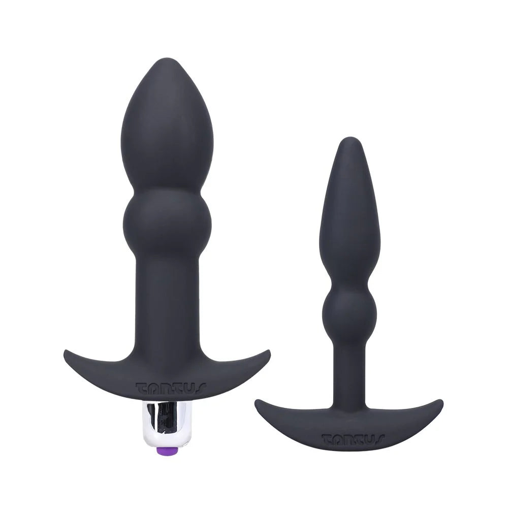 Two black silicone butt plugs with 'Tantus' branding on a white background
