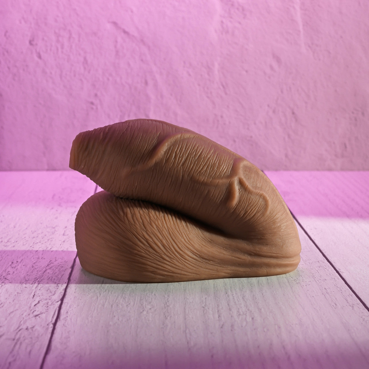 Brown tFTM packer on a pink and white striped surface with a pink background