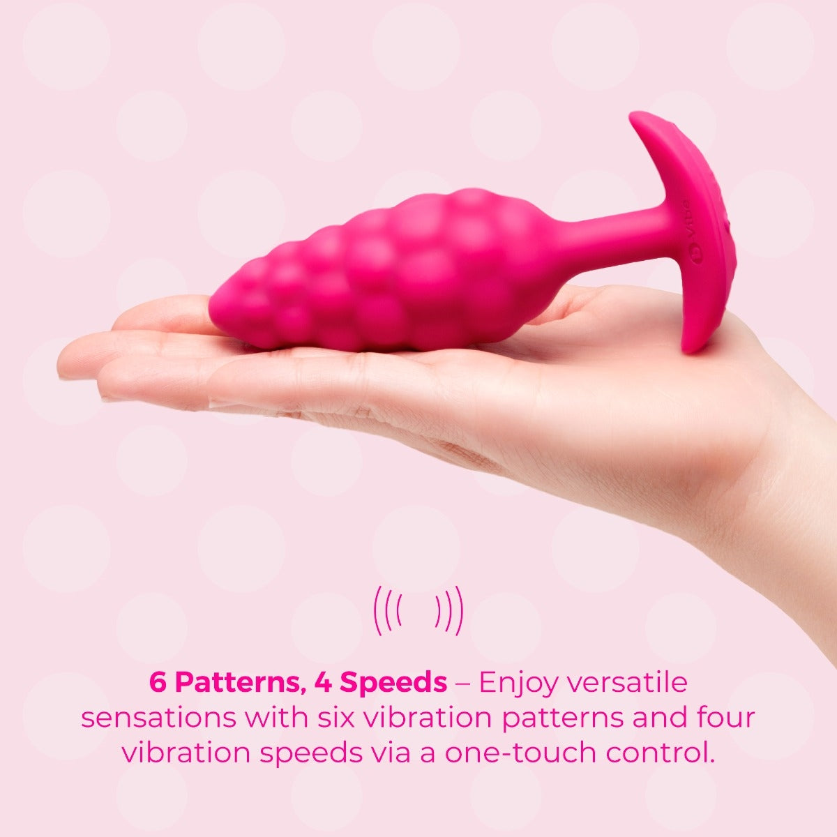 Pink textured b-Vibe Bump Texture Plug Small held in a hand with product features on a pink background